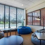 lounge area with bean bag chairs, lamps and tables