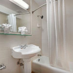 guest room bathroom shower, sink and vanity