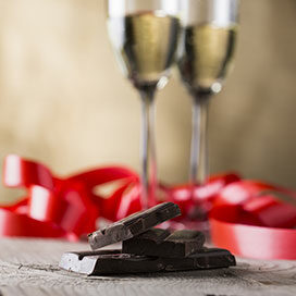 chocolate and two champagne glasses with red ribbon